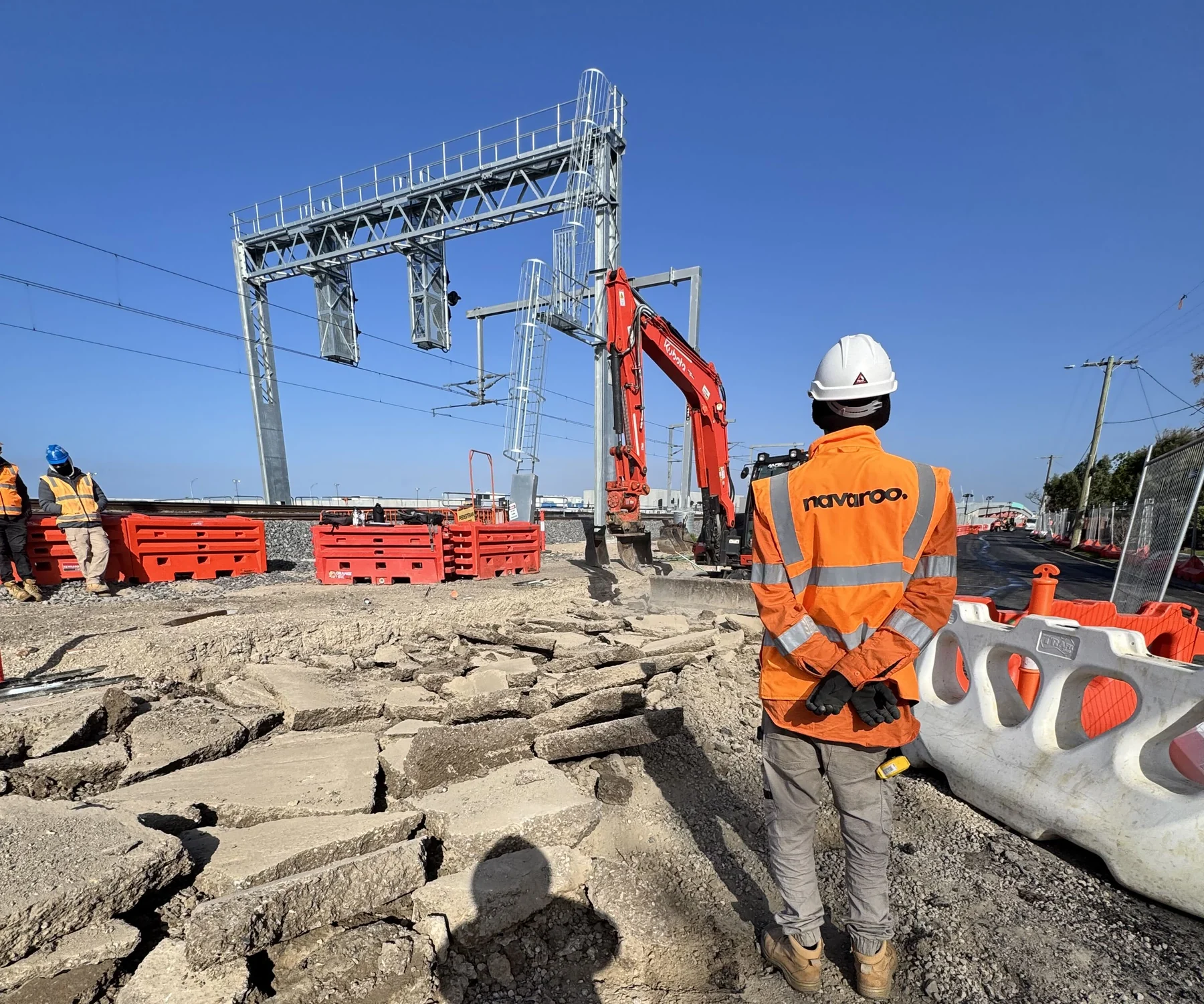 Navaroo worker observing a live transport-infrastructure workfront.
