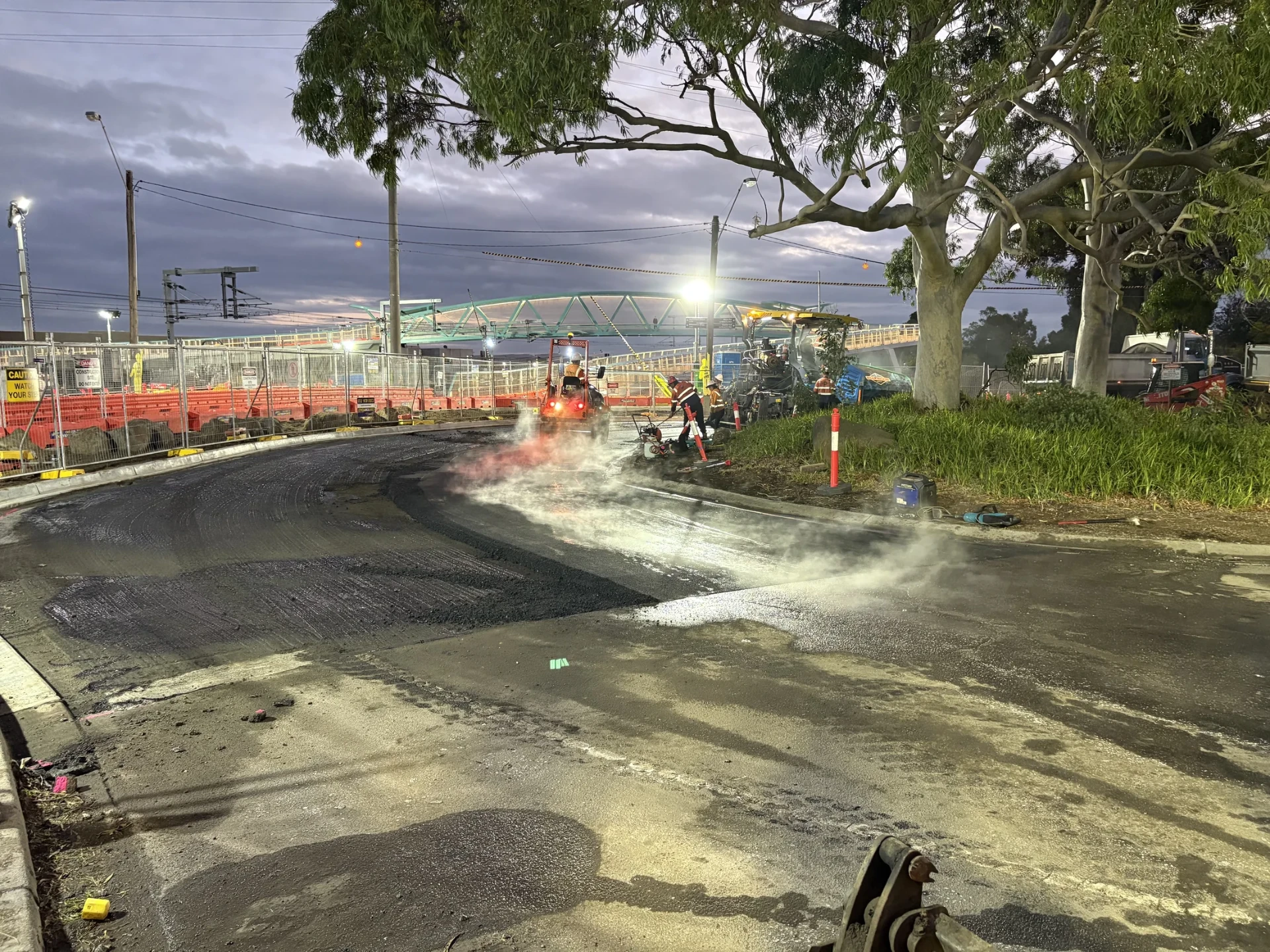 Specialist surfacing works underway at night within the Newport external works package.